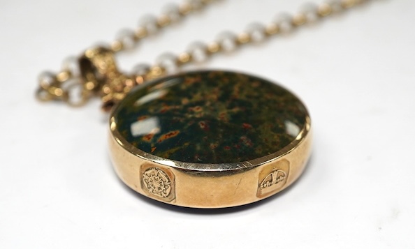 A modern 9ct gold mounted hardstone set circular pendant, 32mm, on a 9ct chain, 60cm, gross weight 38.7 grams. Condition - fair